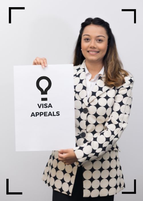 Migration Lawyer with a Visa Appeals placard
